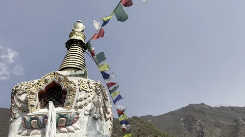Stupa with prayer flags against a clear sky, Nepal Stock Footage 285755332