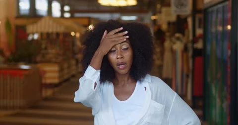 Stupefied multi-ethnic dark-skinned charming woman with afro hairstyle, putting Stock Footage 228033684