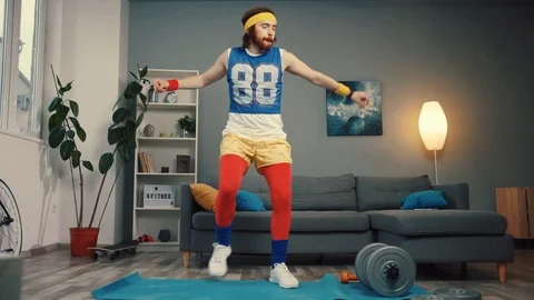 Stupid-looking funny athlete man in retro outfit dancing and warming up having Stock Footage 110833341