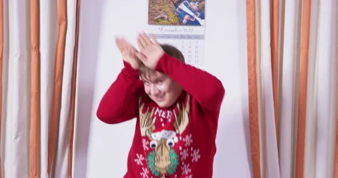 Stupid man in ugly red sweater with deer funny dances finger dance waving arms Stock Footage 248572215