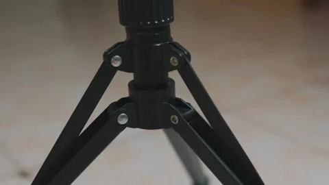 Sturdy Black Tripod Base Close-up with Legs and Central Column Providing Support Stockbeeldmateriaal 333317685