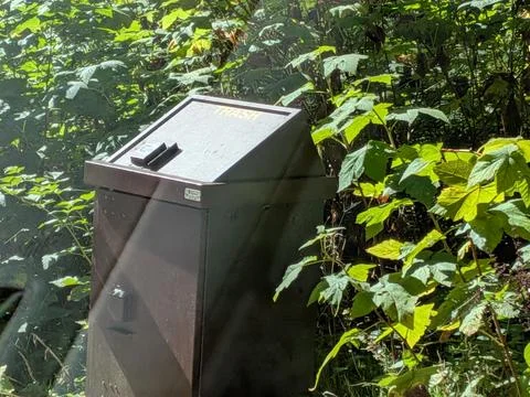 A sturdy brown bear-proof trash bin designed to protect wildlife Stock Photos