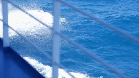 A sturdy metal railing frames the oceans blue waves below, highlighting the.. Stock Footage 291590040