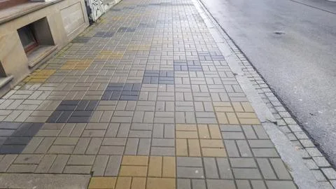 Sturdy patterned sidewalk pavement made of rectangular tiles in neutral tones, Stock Photos