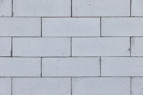 Sturdy white bricks form an intricate wall pattern in natural light at midd.. Stock Photos