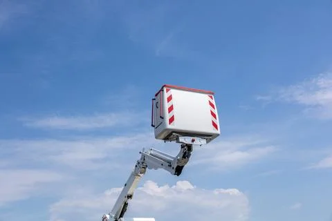A sturdy work platform extends high into the sky, ready for repair tasks in.. Stock Photos
