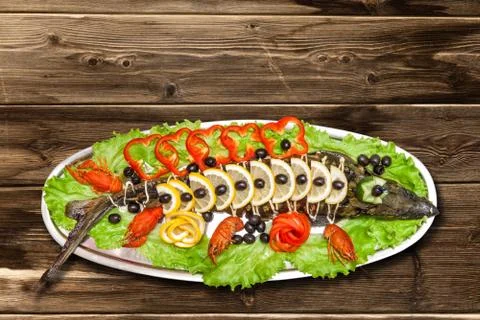 Sturgeon in the lemon on a plate Stock Photos