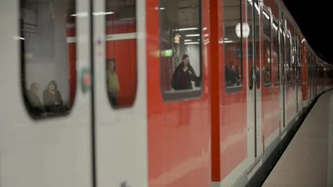 Stuttgart, Germany - 04/16/2023: Red train departing station with Stock Footage 281840598