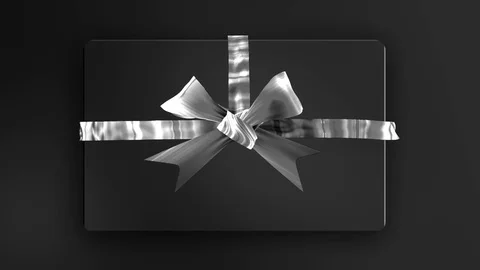 Style Silver Ribbon bows opening and unpacking a black gift present top view Stock Footage 83538211