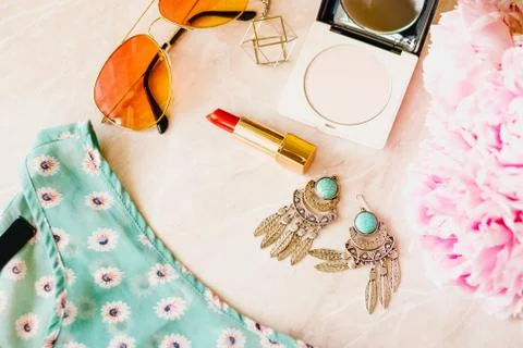 Styled flat lay background. Pink peony flower with jeans and shoes. Stock Photos