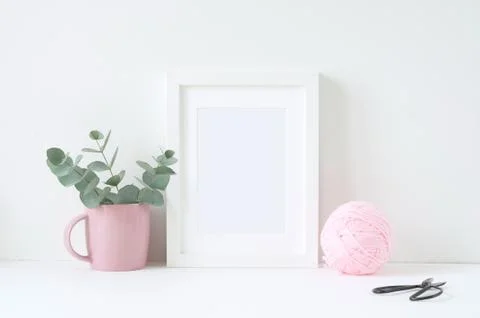 Styled mockup with white frame and pink ranunculos Stock Photos