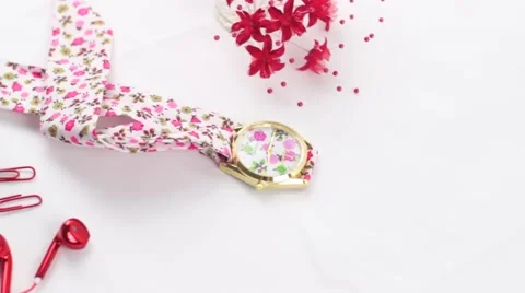 Styled video floral watch red flower headphones online presence branding Stock Footage 68533417