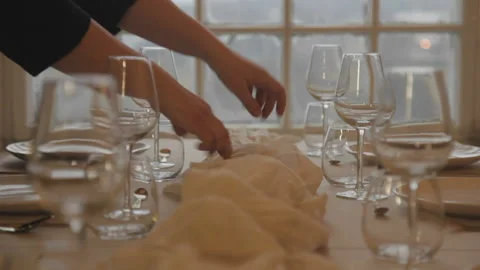 Styling a table setting with table runner Stock Footage 168330128