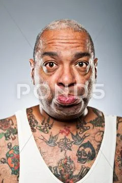 Stylish african american man with many tattoos pouting Stock Photos