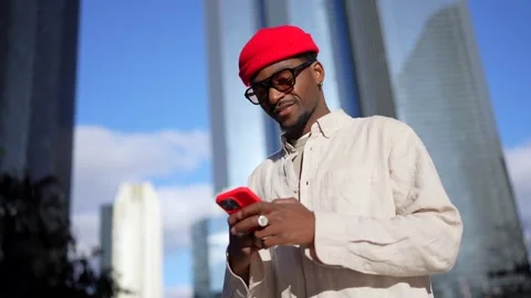 Stylish african american man using smartphone in downtown city Stock Footage 323069959