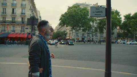 Stylish and active older couple walk arm-in-arm while out on a date in the city. Stock Footage 112062754