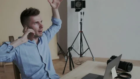 Stylish and expressive happy guy speaking on the cellphone. He is wonder and Stock Footage 107781633