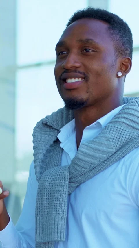 A Stylish and Handsome Man Engaged Deeply with His Smartphone in a Modern Urban Stock Footage 314149433