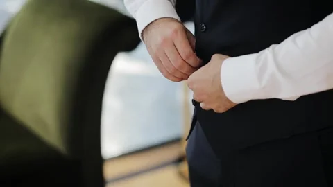 Stylish arabic young man in a suit buttoning black jacket. Close up of groom Stock Footage 204123865