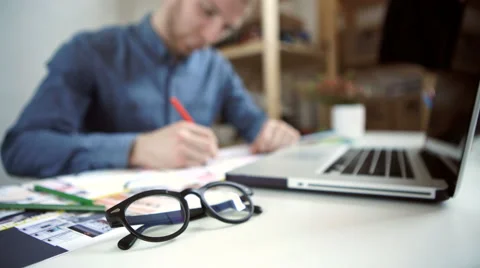 Stylish architect working on blueprint Stock Footage 62762645