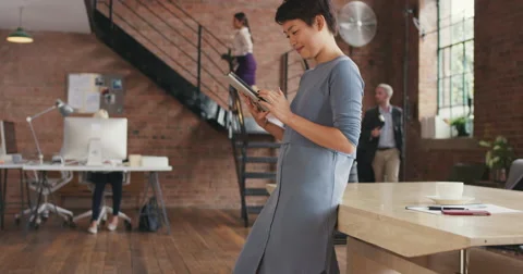 Stylish Asian Business woman using digital tablet in boardroom Stock Footage