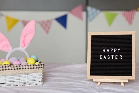 Stylish background with colorful easter eggs pastel colors in basket on bed Stock Photos