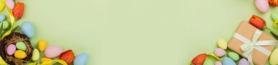 Stylish background with colorful easter eggs pastel colors isolated on green 스톡 사진