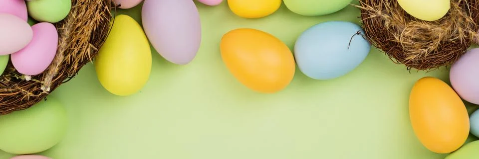 Stylish background with colorful easter eggs pastel colors isolated on green  Stock-Fotos