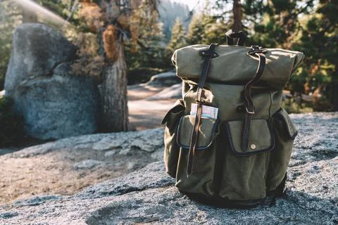 Stylish backpack located on stone ground in Yosemite National Park Stock Photos