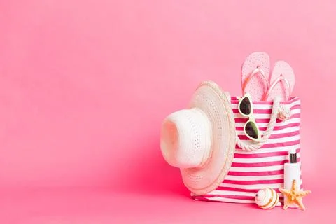 Stylish bag with beach accessories . Summer holiday concept. Top view of beac Stock Photos
