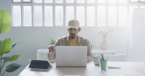 Stylish bearded freelancer working remotely from home. Millennial working on Stock Footage 269689282