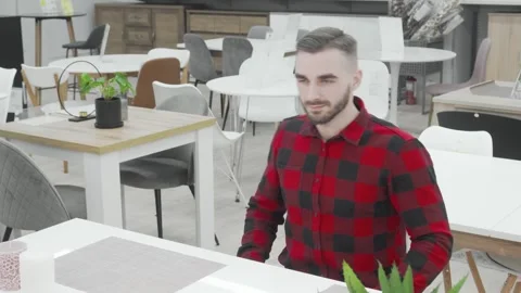 Stylish bearded man exploring modern furniture options Stock Footage 311537862