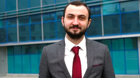 Stylish bearded man wearing elegant clothes standing in downtown, nodding his Stock Footage 145604591