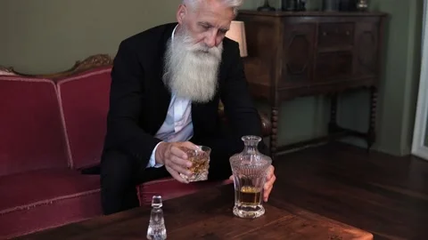 Stylish bearded senior man drinking whiskey Stock-Footage 233631269