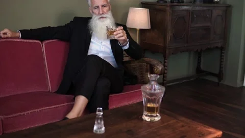 Stylish bearded senior man drinking whiskey Stock Footage 233631391
