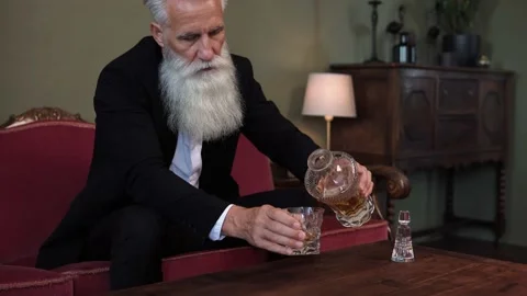 Stylish bearded senior man drinking whiskey Stock-Footage 233631550