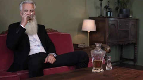 Stylish bearded senior man drinking whiskey Stock Footage 233654308