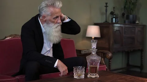Stylish bearded senior man drinking whiskey Stock Footage 233654571