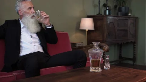 Stylish bearded senior man drinking whiskey Stock Footage 233654576