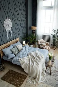 Stylish bedroom setup includes rustic wooden bed, soft blue bedding, and Foto stock
