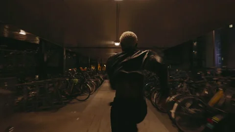 Stylish Black Guy In Leather jacket Is Running. Night City. Many Bikes In Bike Vidéo 212627809
