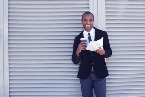 Stylish black man documents handling outdoors Stock Photos