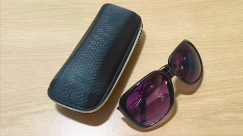 Stylish black sunglasses with a protective case are ready for a sunny adventure, Stockbeeldmateriaal 318610852