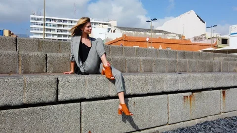 Stylish Blonde Model Sitting by the Cement Stairs Stock Footage 116111858