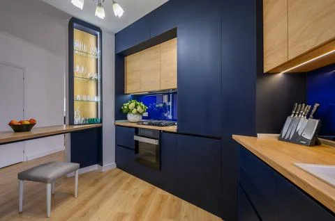 Stylish blue colored studio studio apartment with kitchen open to living room Stock-Fotos