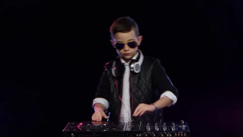 Stylish boy dj with glasses playing on vinyl. Black background Stock Footage 75897766