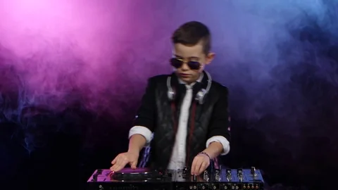 Stylish boy dj with glasses playing on vinyl. Smoky background Stock-Footage 75898532
