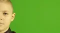 The stylish boy smile on the green background. Half face view 4k or 4k+ Resolution