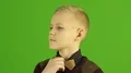 The stylish boy smile on the green background 4k or 4k+ Resolution