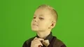 The stylish boy smile on the green background 4k or 4k+ Resolution